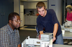 Trainer working with a student on a computer